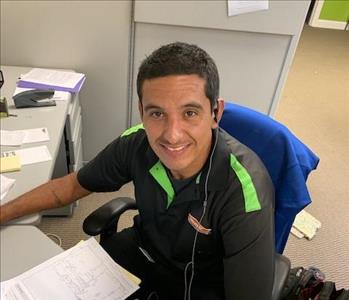 dark haired male worker at desk