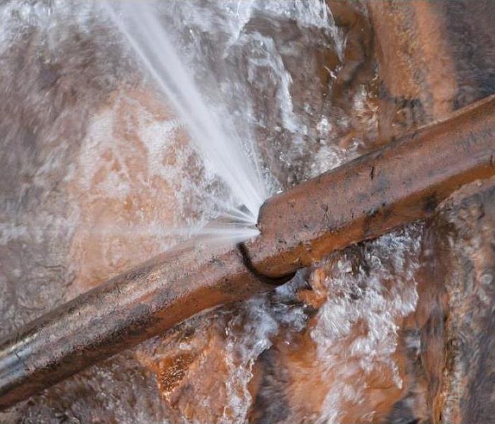 metal pipe with water spraying out of it